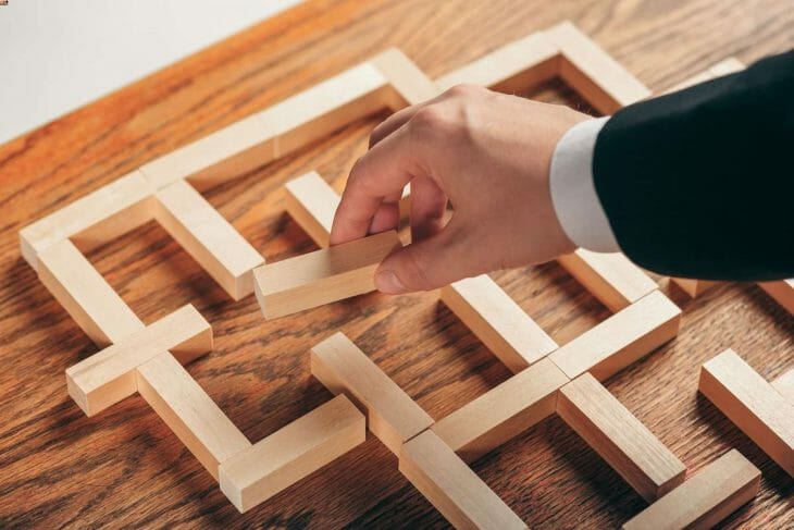 Man putting the wooden puzzle