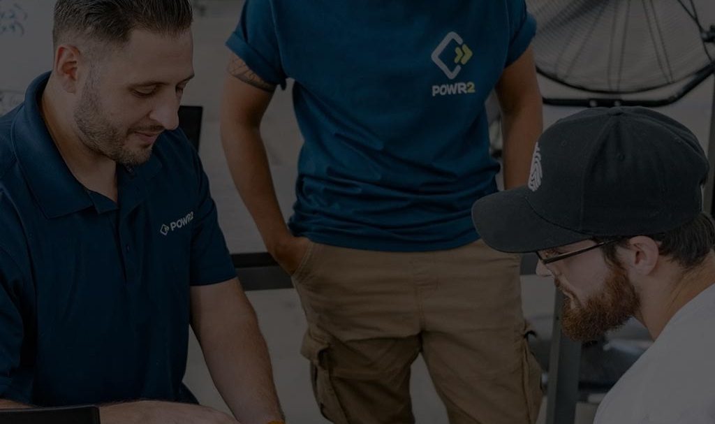 A background image for POWR2 of repair workers on the job